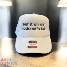 Load image into Gallery viewer, Put It On My Husband's Tab Embroidered Trucker Hat